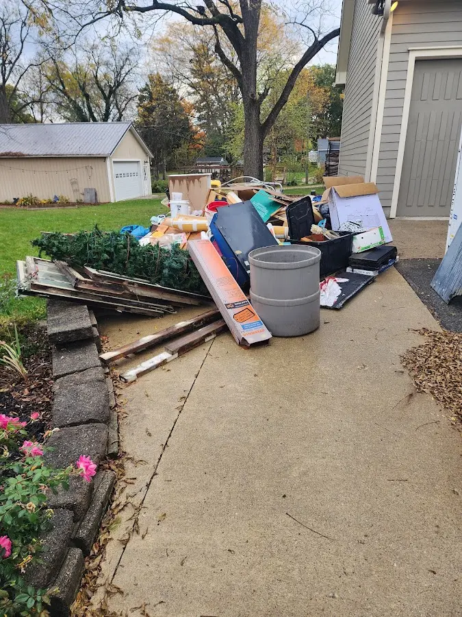Dumpster being loaded with debris for Commercial Dumpster Rental in Peoria
